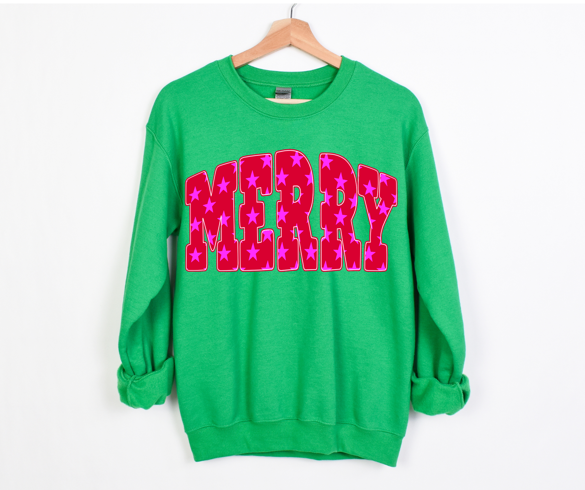 Green sweatshirt with 'MERRY' in pink letters on a white background