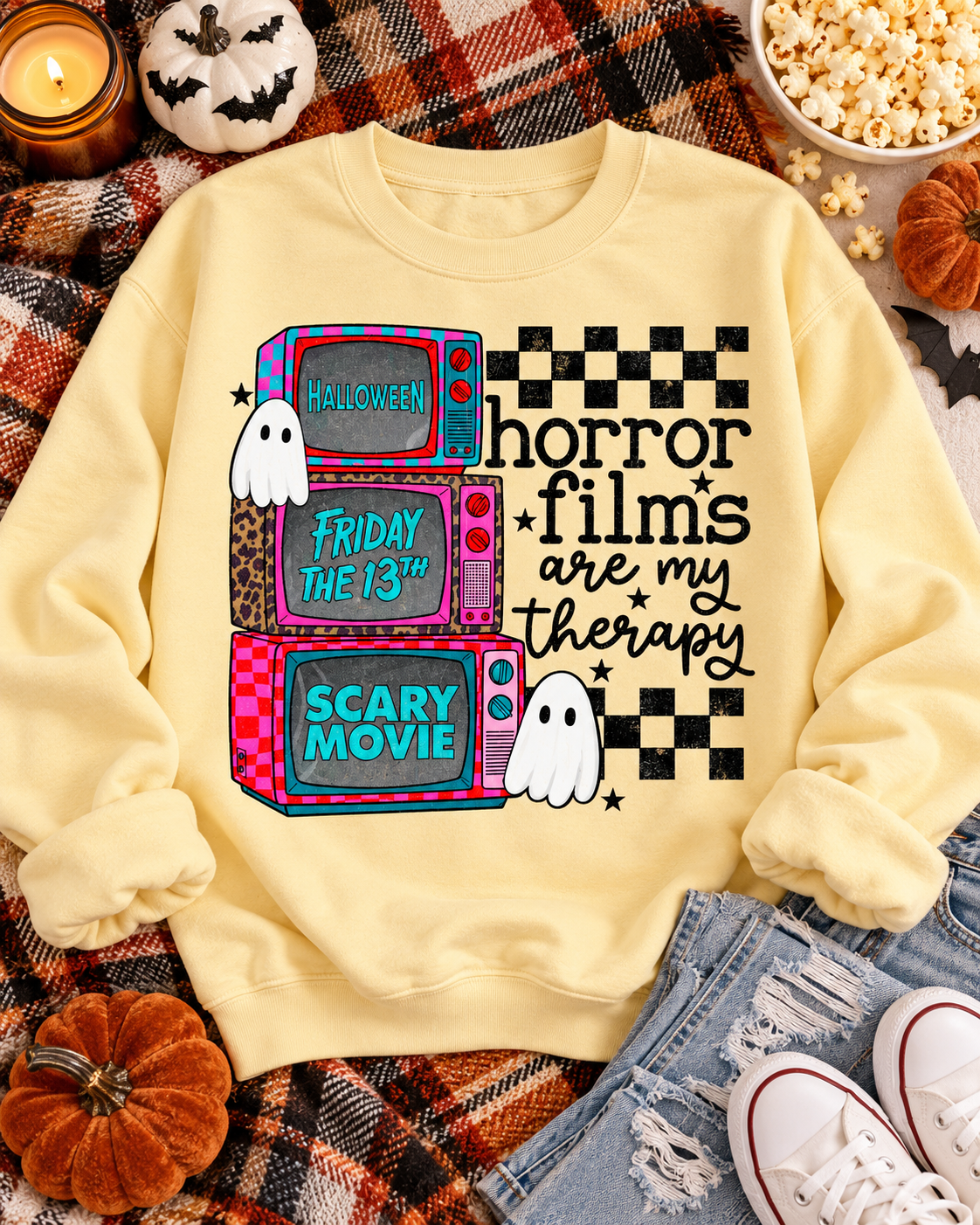 Horror Films Are My Therapy Halloween graphic on a cozy fall sweatshirt flat lay
