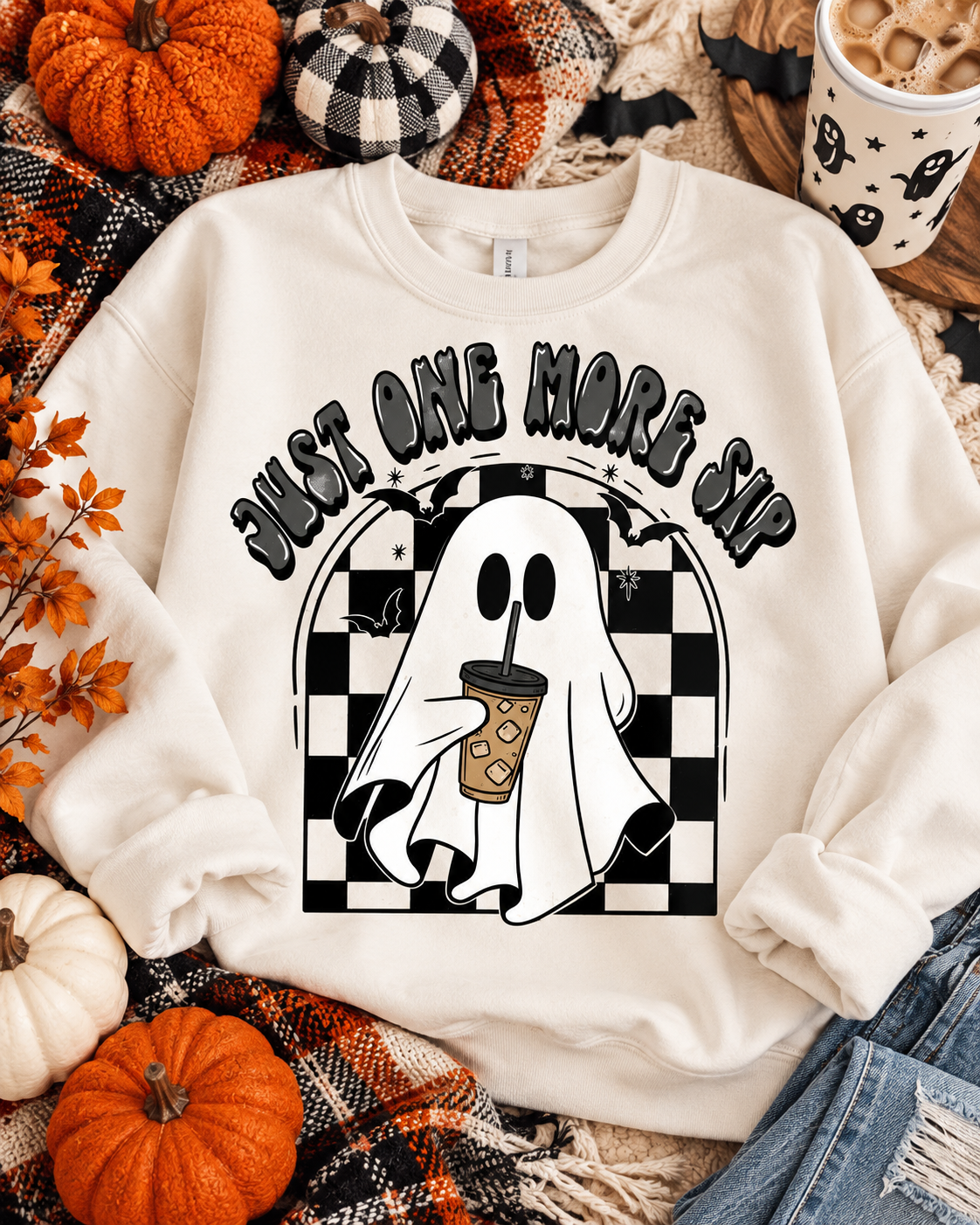 Just One More Sip ghost coffee graphic on a cozy fall sweatshirt flat lay