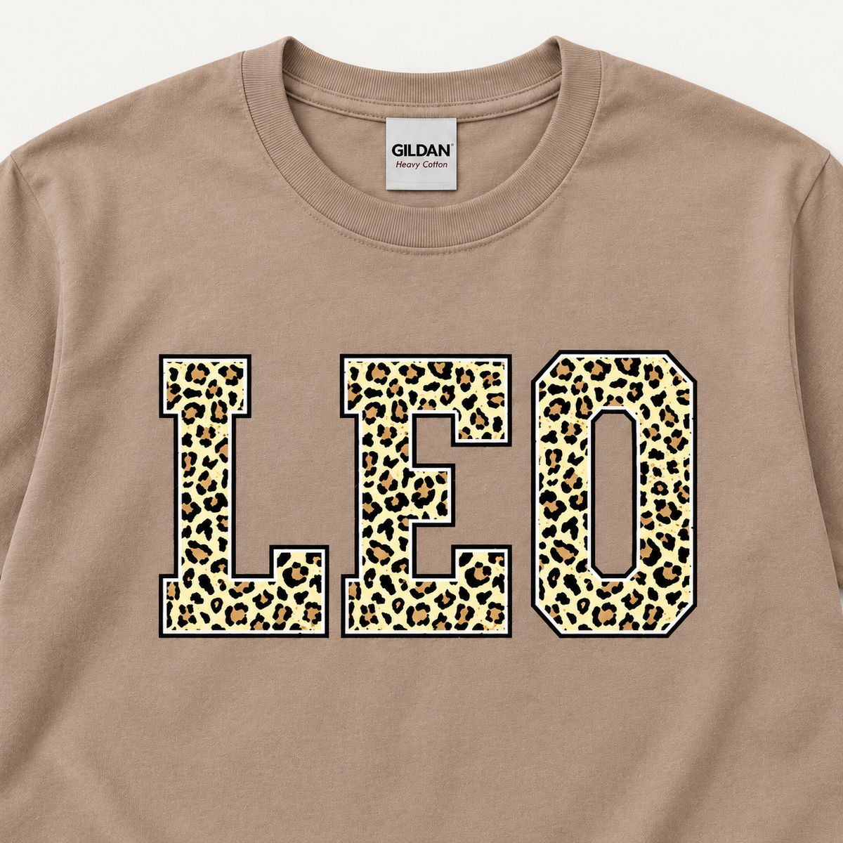 Close-up of LEO leopard print on Brown Savanna tee