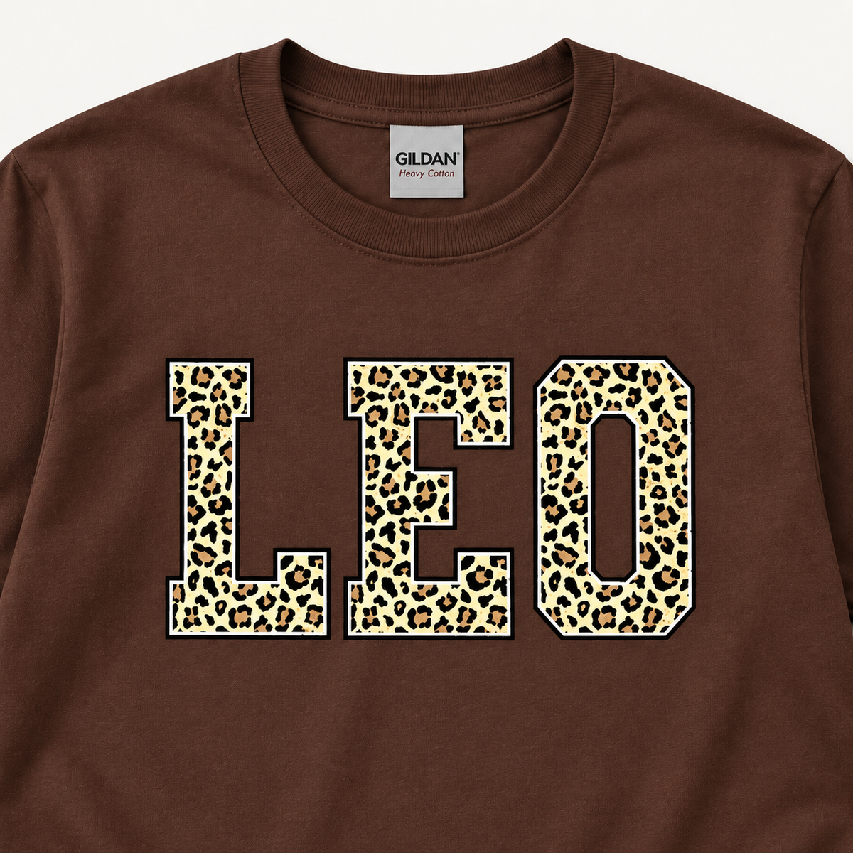 Close-up of LEO leopard print on Dark Chocolate tee