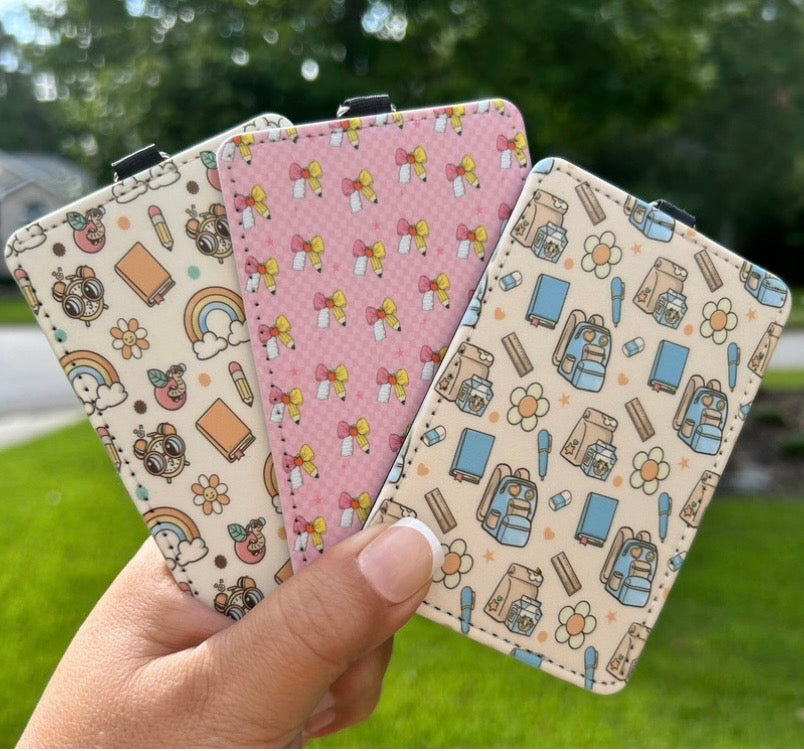 Three finished patterned ID badge holders including pink bow design