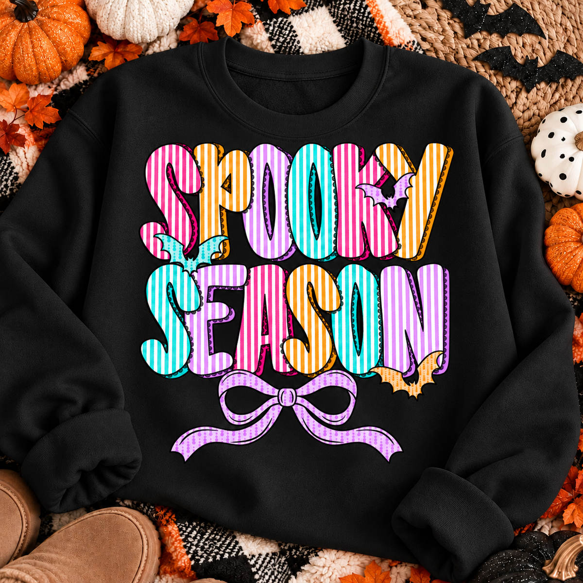Spooky Season Bow on a black crewneck sweatshirt Halloween flat lay