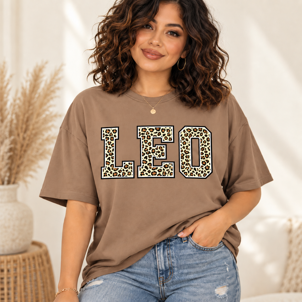 Leo leopard zodiac graphic tee modeled by a curly-haired Latina woman