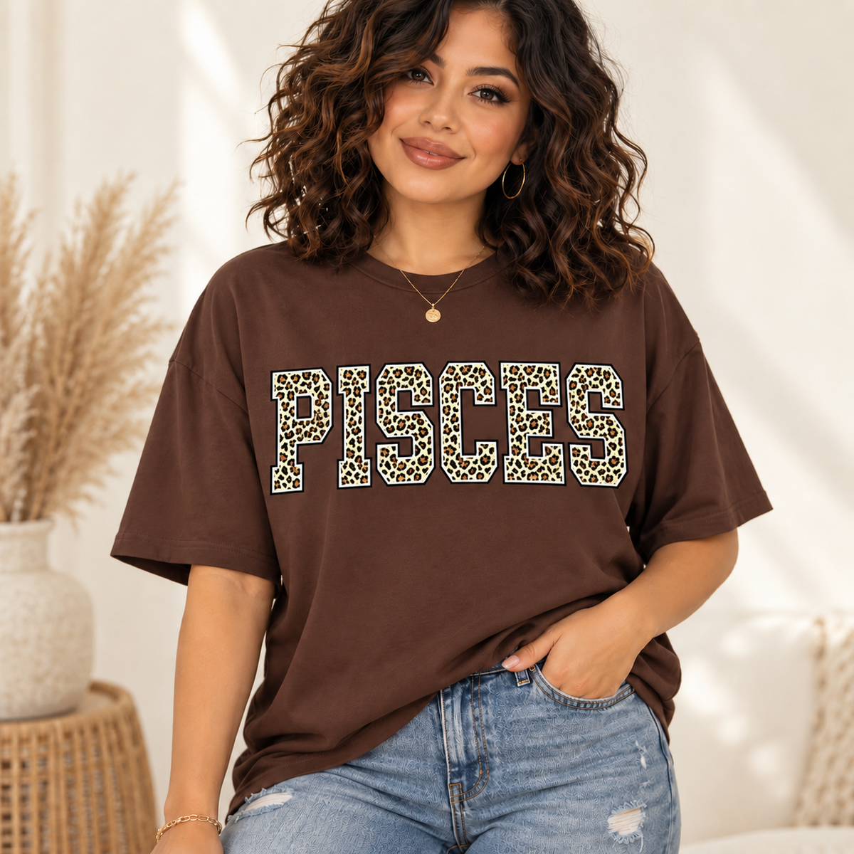 Pisces leopard zodiac graphic tee modeled by a curly-haired Latina woman